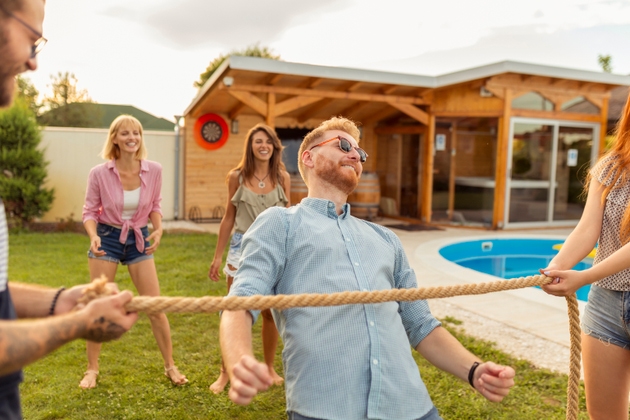 Friends dancing limbo at summertime party