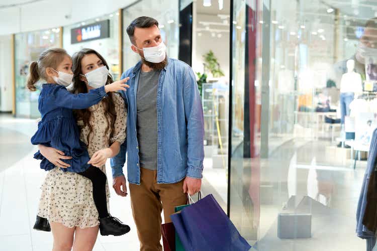 Family strolling in shopping mall during a pandemic