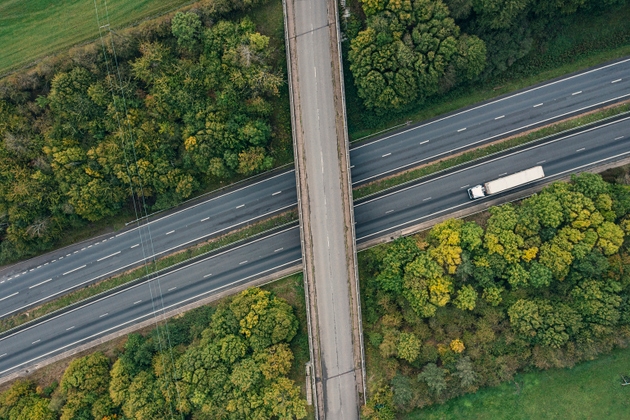 Drone point of view of an articulated lorry on a major road