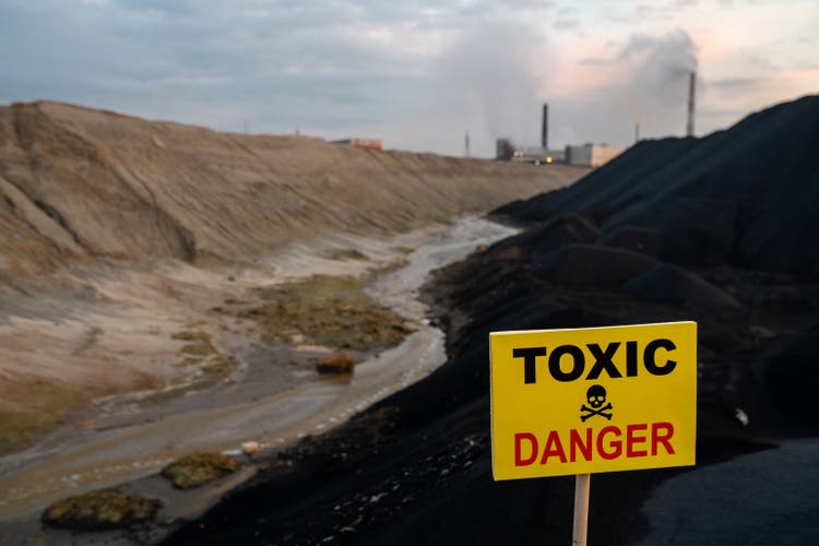 Stronghold Digital Mining: A Powerful Option On Bitcoin At A Discount To NAV - Seeking Alpha Notice on rectangular yellow board announcing about toxic and dangerous area against dirty river