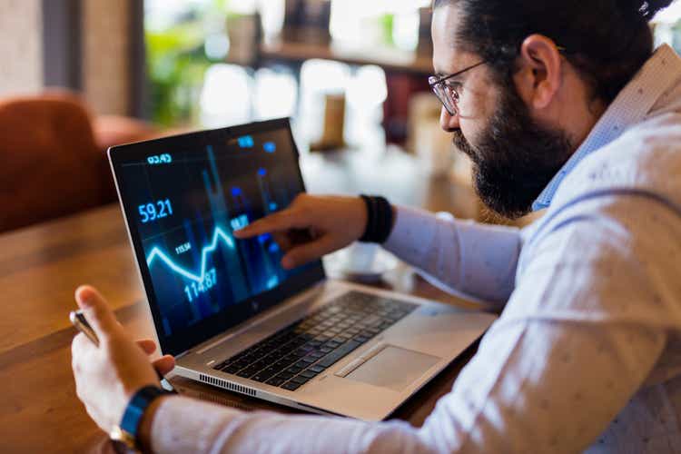 Businessman using laptop for analyzing data stock market