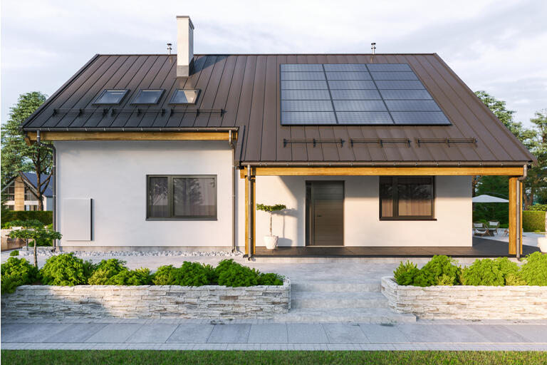 Modern House With Solar Panels And Wall Battery For Energy Storage