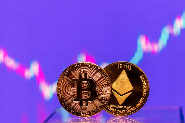 Cryptocurrency bitcoin and ethereum coin displayed on stock charts with market quotes