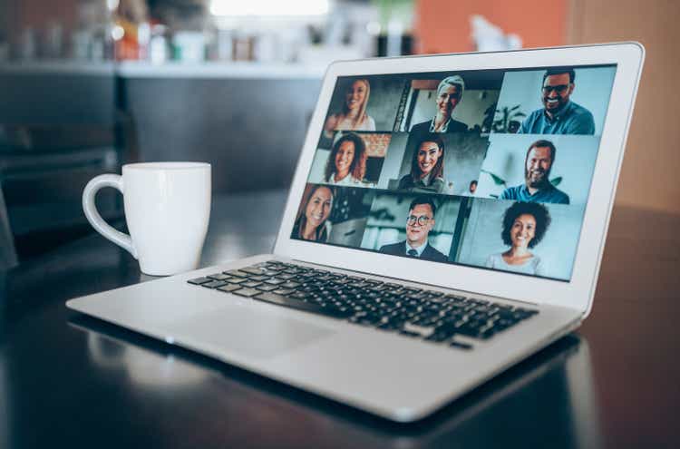 Laptop with a video conference call on the screen.