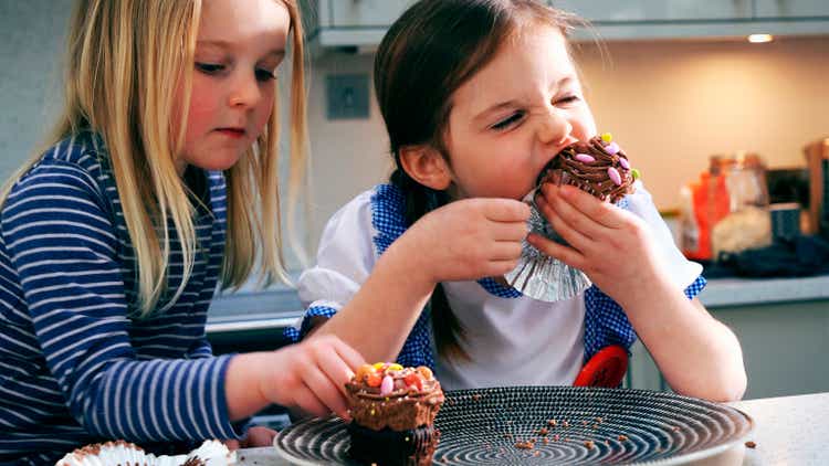 two girls eating cupcakes