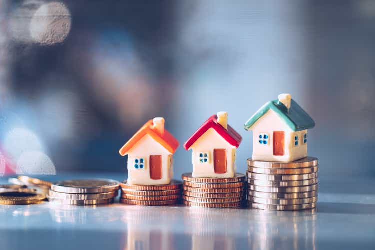 Miniature colorful house on stack coins