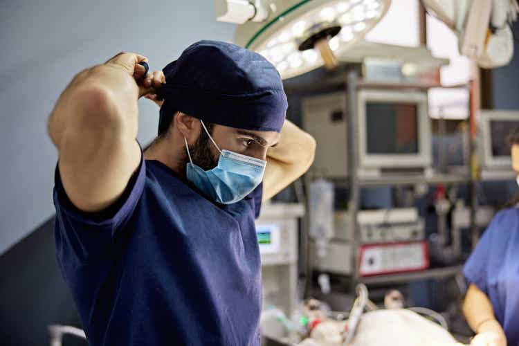 Male Veterinarian Putting on Surgical Cap Before Procedure