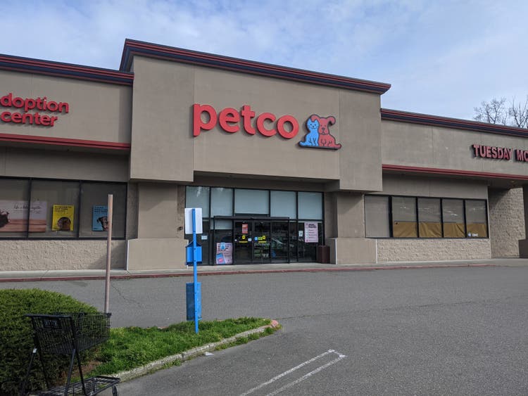 Street view of the entrance to a Petco pet supply store.