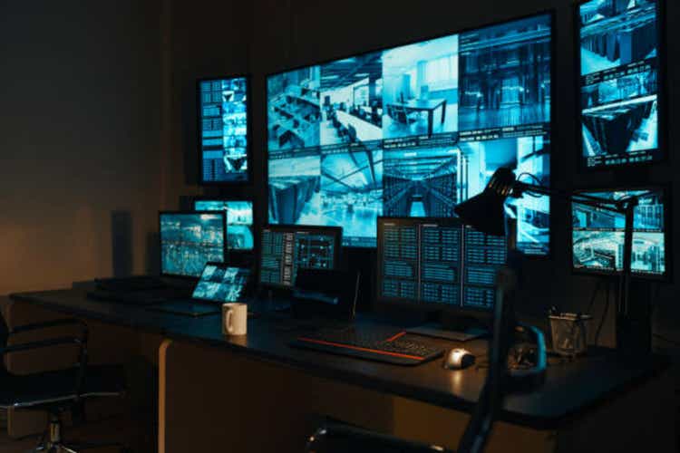 A security workplace with a modern high-tech control panel in the form of large monitors that display real-time information from external video surveillance cameras for 24 hours.