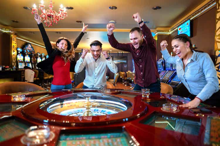 Group Of Friends Playing Roulette In Casino