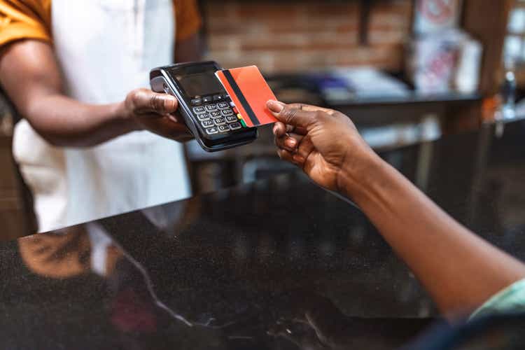 Cropped shot of an unrecognizable woman paying for her purchase by card