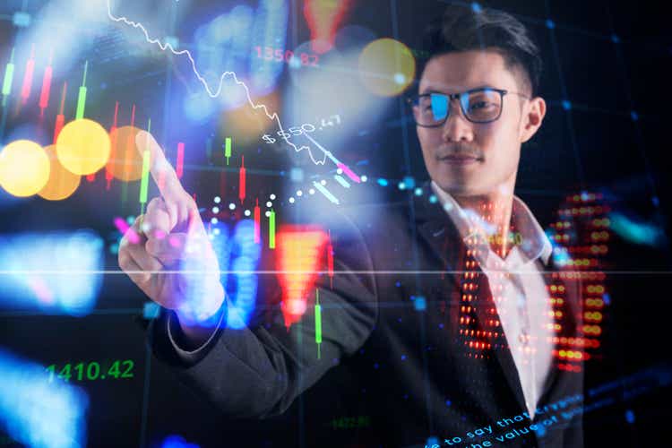 Smart businessman finger pointing financial data futuristic business invest stock exchange market and crypto currency graph chart finance business wealth growth ideas background