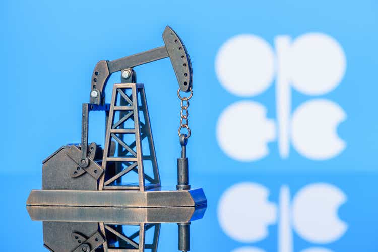 Petroleum, petrodollar and crude oil concept : Pump jack and flag of OPEC or Organization of Oil Exporting Countries