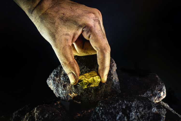 large gold stone being removed from mine, concept of mineral extraction and gold excavation