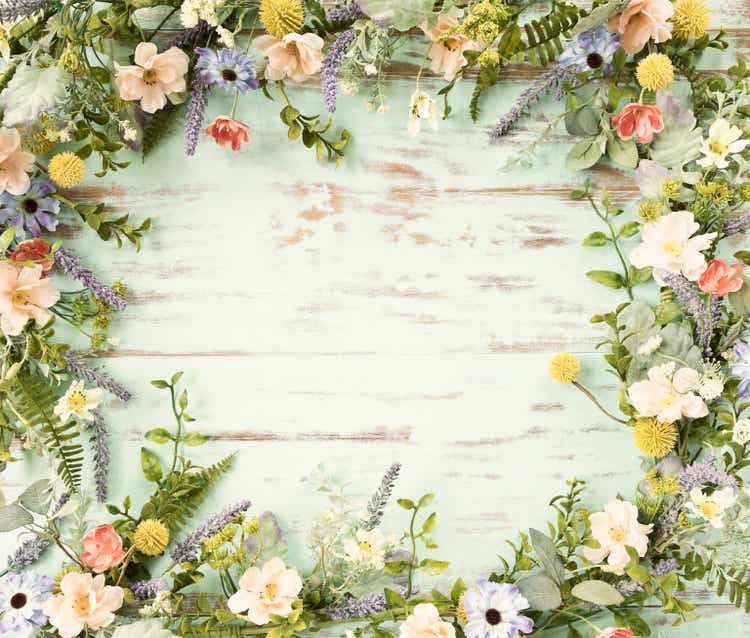 Spring flower wreath garland frame on an old rustic blue wood background