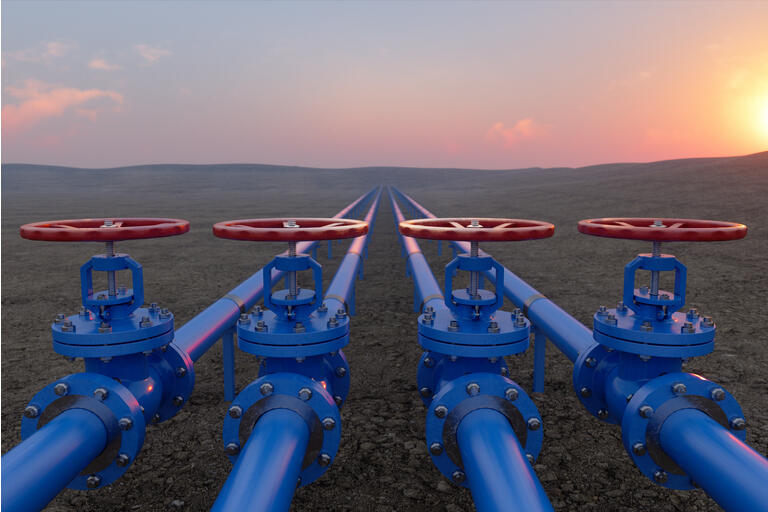 Oil Or Gas Transportation With Blue Gas Or Pipe Line Valves On Soil And Sunrise Background