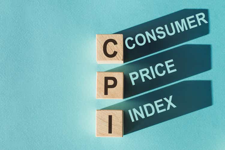 Wooden cubes building word CPI - (abbreviation Consumer Price Index) on light blue background.