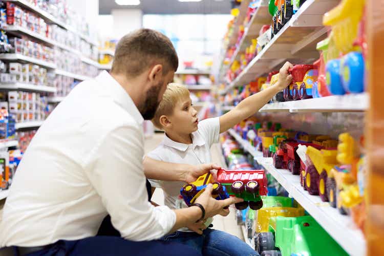 A dad with a small child is shopping at a children