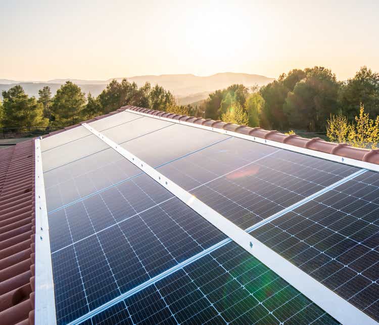 Solar panels on the roof of a House at sunset