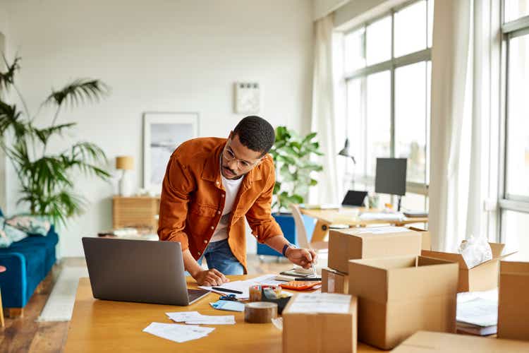 Businessman Analyzing Documents In Home Office