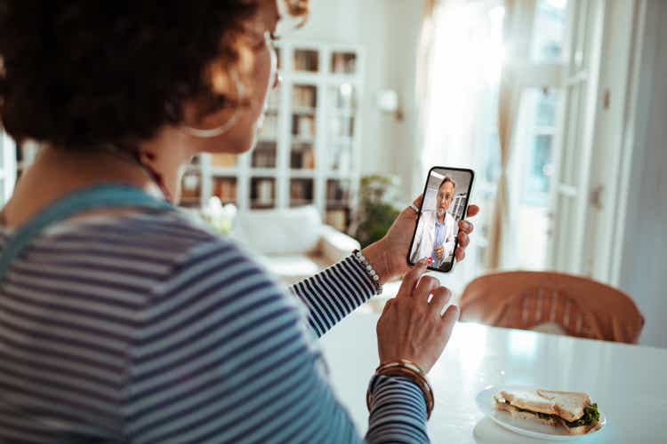 Pregnant lady talking to her doctor on a video call