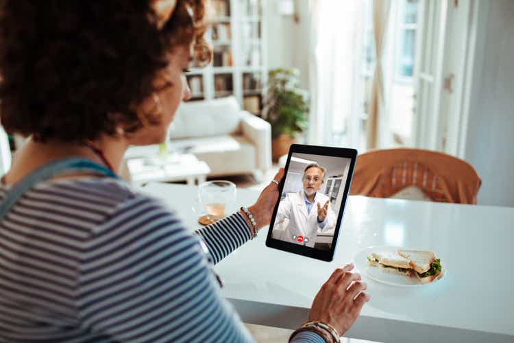 Pregnant lady talking to her doctor on a video call