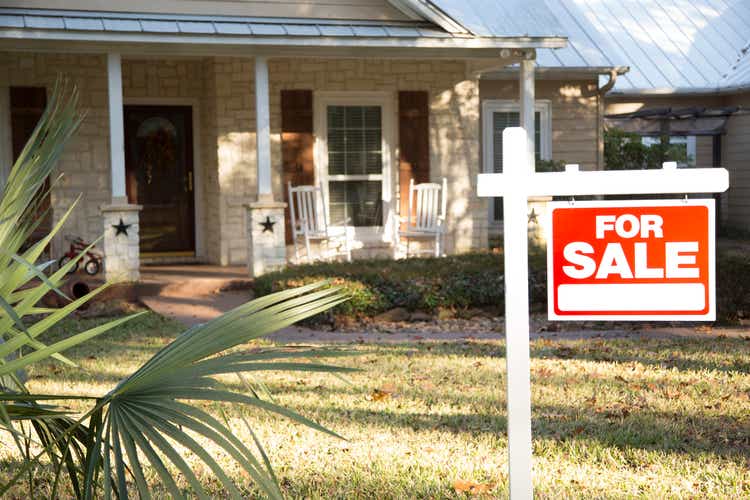 Home for sale with real estate sign. Front Yard.