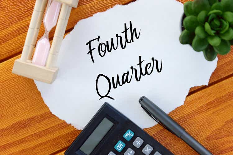 Top view of calculator,pen,sand clock,plant and paper written with Shareholder on wooden background.Business and finance concept.