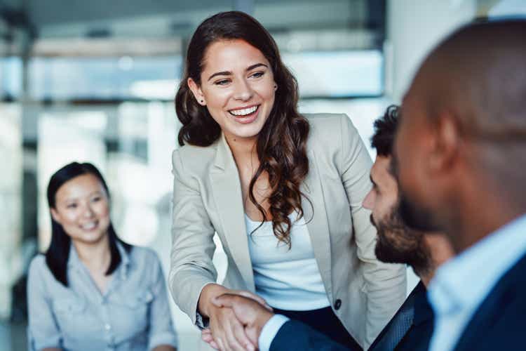 Shot of a young businesswoman shaking hands with a colleague during a meeting in a modern office