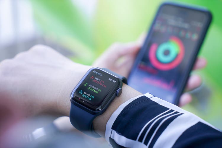 Woman using smart watch and smart phone, Apple watch