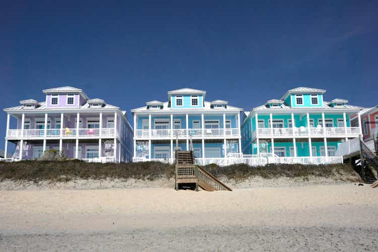 Row of multicolored houses on a sandy beach