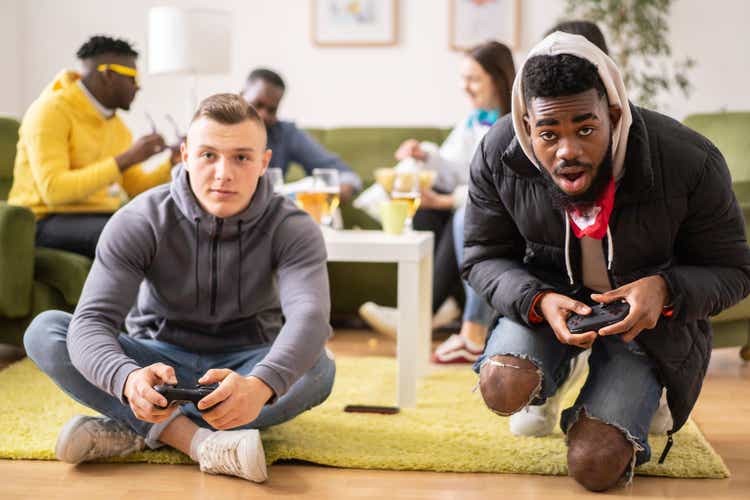 Two friends competing on a video game