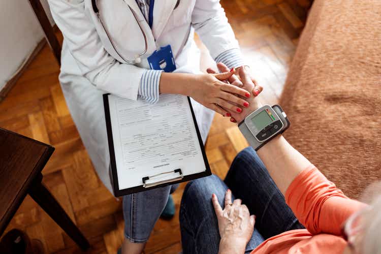 Health visitor and a senior woman during nursing home visit