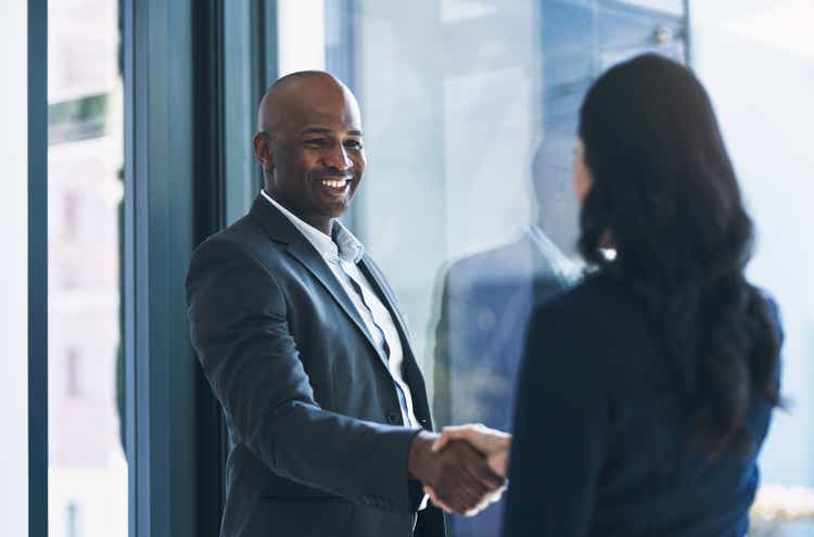 Shot of a mature businessman shaking hands with a colleague in an office