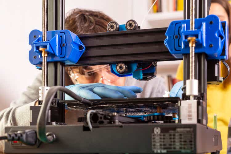 Modern 3D printer printing figure close-up
