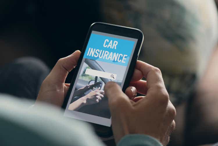 man searching a car insurance on his smartphone