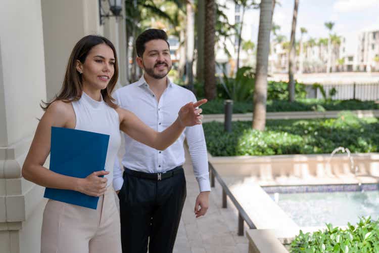 Real estate agent showing the outdoor areas of a property to a client