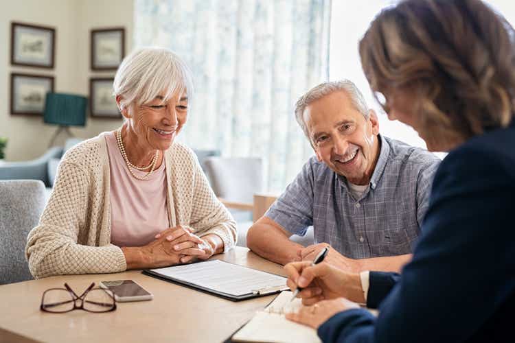 Senior couple consulting with financial agent