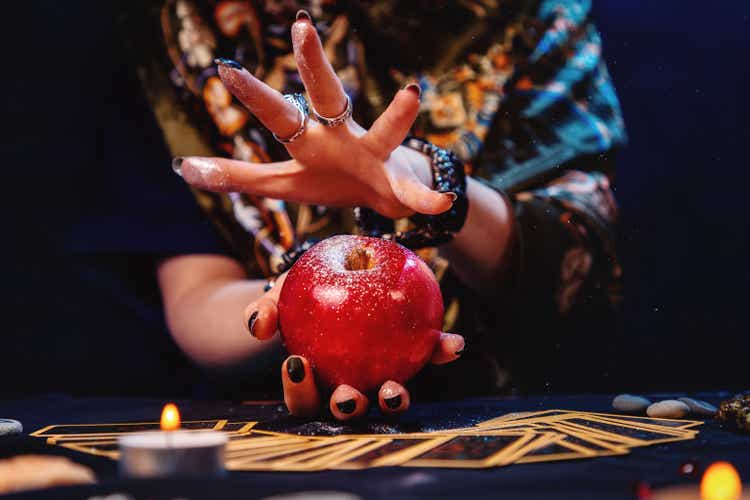 Astrology. A witch conjures an apple. Close-up. The concept of divination, magic and esotericism