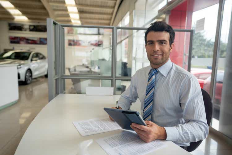 Car salesperson working at the dealership