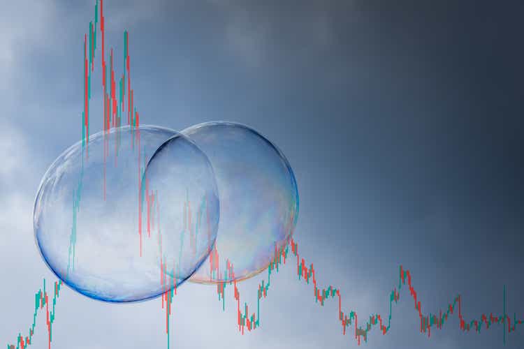 symbolic picture of a stock market bubble with a parabolic chart entering a recession with finishing its market cycle with a financial tsunami, copy space on the right side.