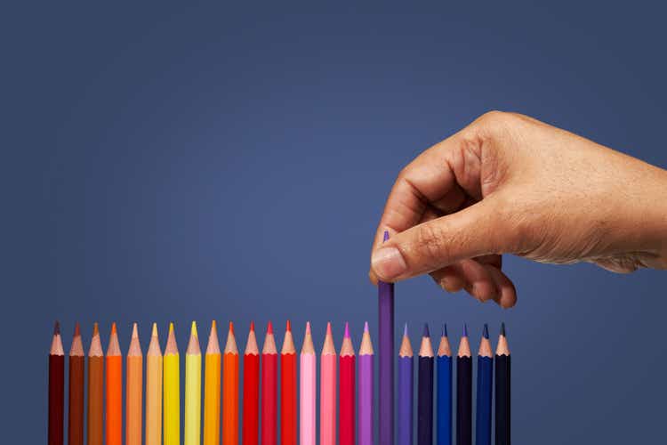 Hand picking colored pencils