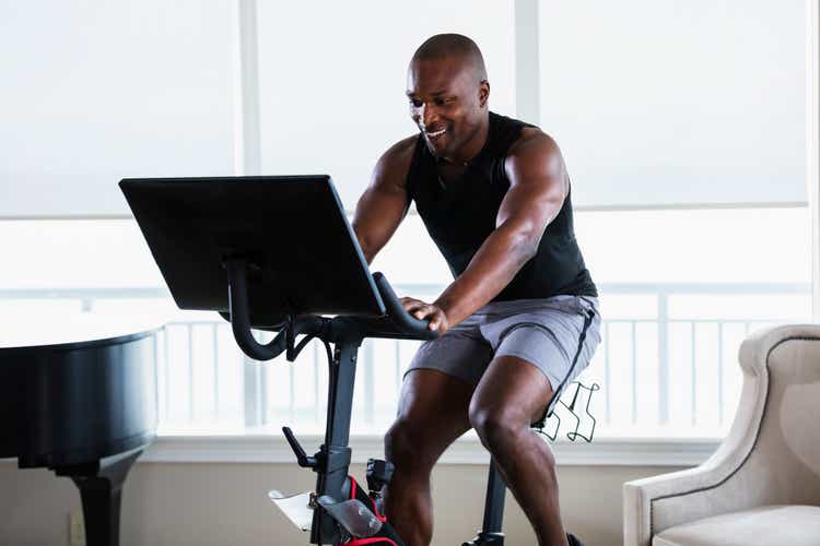 African-American man on exercise bike at home