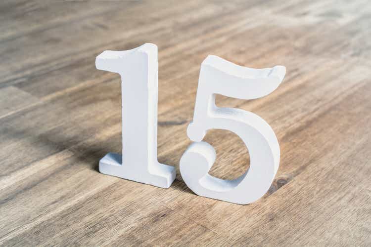 Number 15 Standing On A Brown Wooden Table