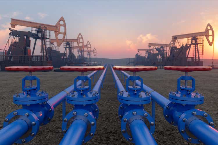 Petrochemical Plant With Blue Pipe Line Valves On Soil And Pumpjacks