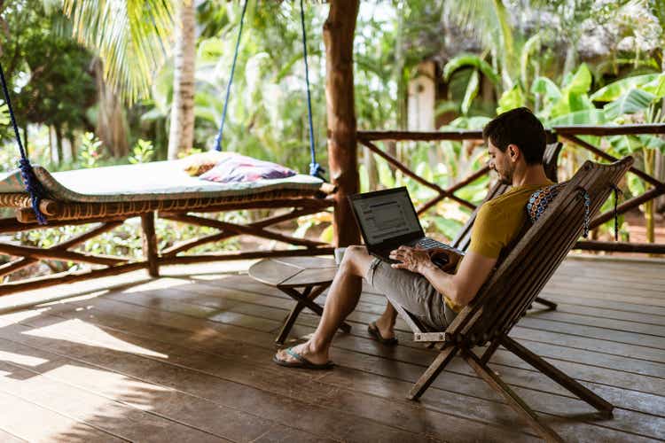 Young man working on a computer outdoors