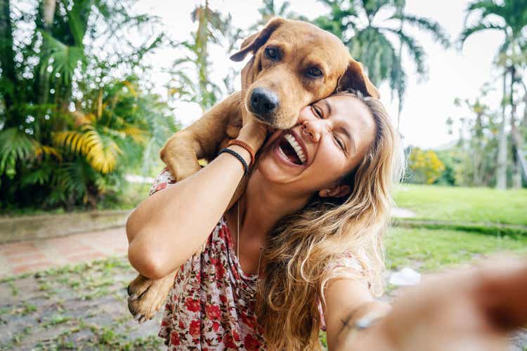 Young Woman Takes Selfie With Her Dog