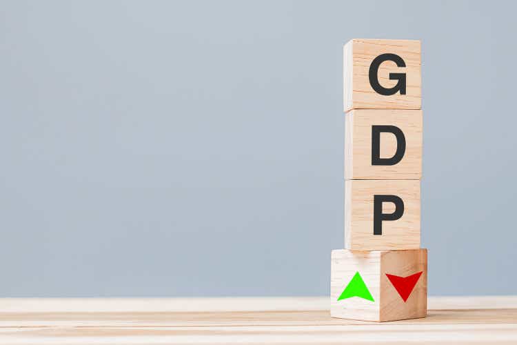 wood cube block with GDP text (Gross domestic product) to UP and Down arrow symbol icon. Financial, Management, Economic and business concepts