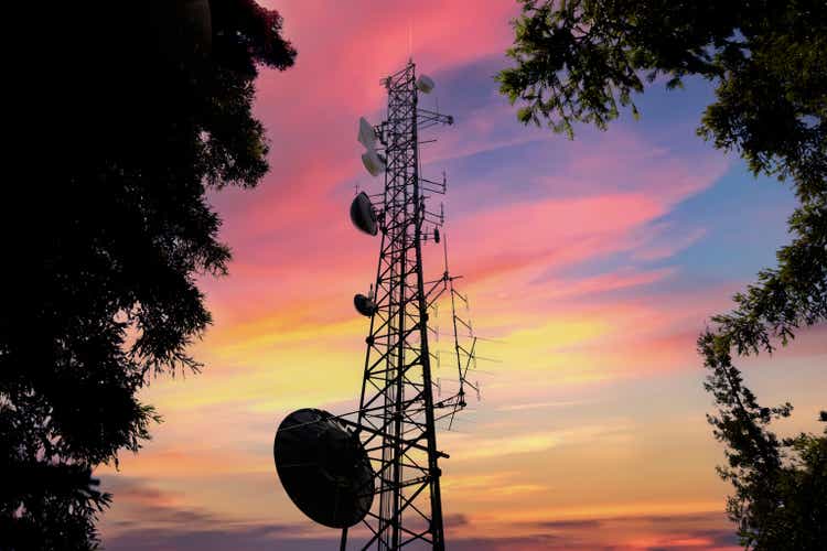 Sunset Cell Tower: Cellular communications tower in rural forest area for mobile phone and internet, video and data transmission
