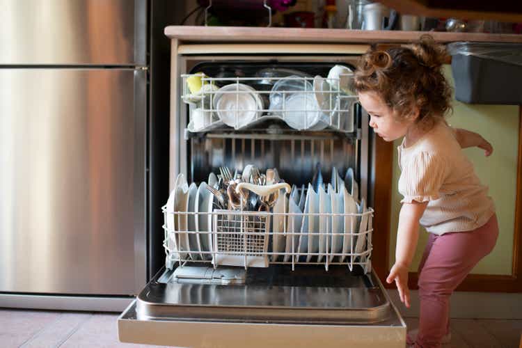Cute little baby girl dishwasher, the concept of the importance of water